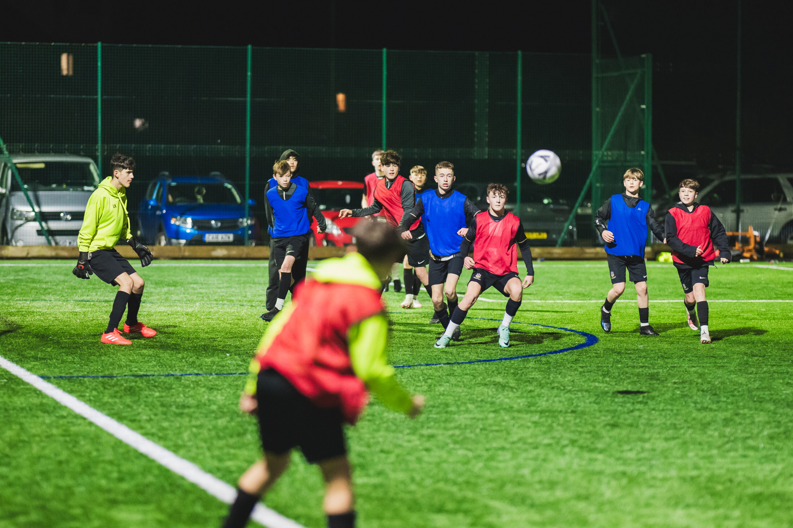 Group of the boys team playing football on a pitch